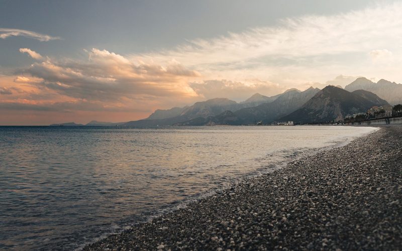 Antalya - Capture of Antalya's coastline at sunset, showcasing tranquil waters and distant