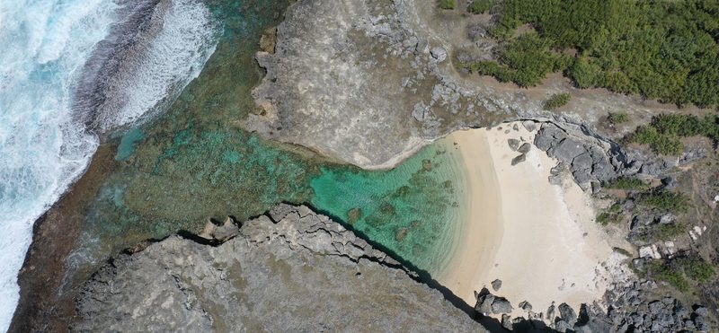 Mauritius - Stunning aerial shot of a secluded beach cove in Rodrigues, Mauritius, showcasin