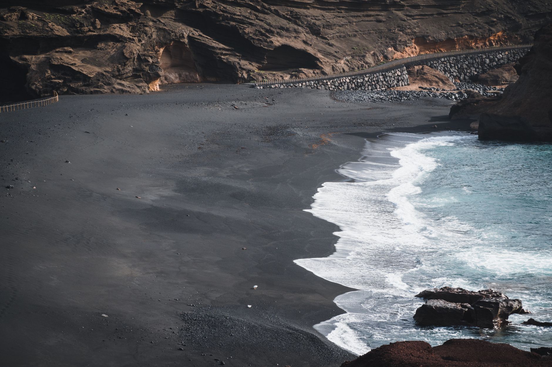 Lanzarote - Scenic view of a rugged black sand beach with waves in Lanzarote, Spain.