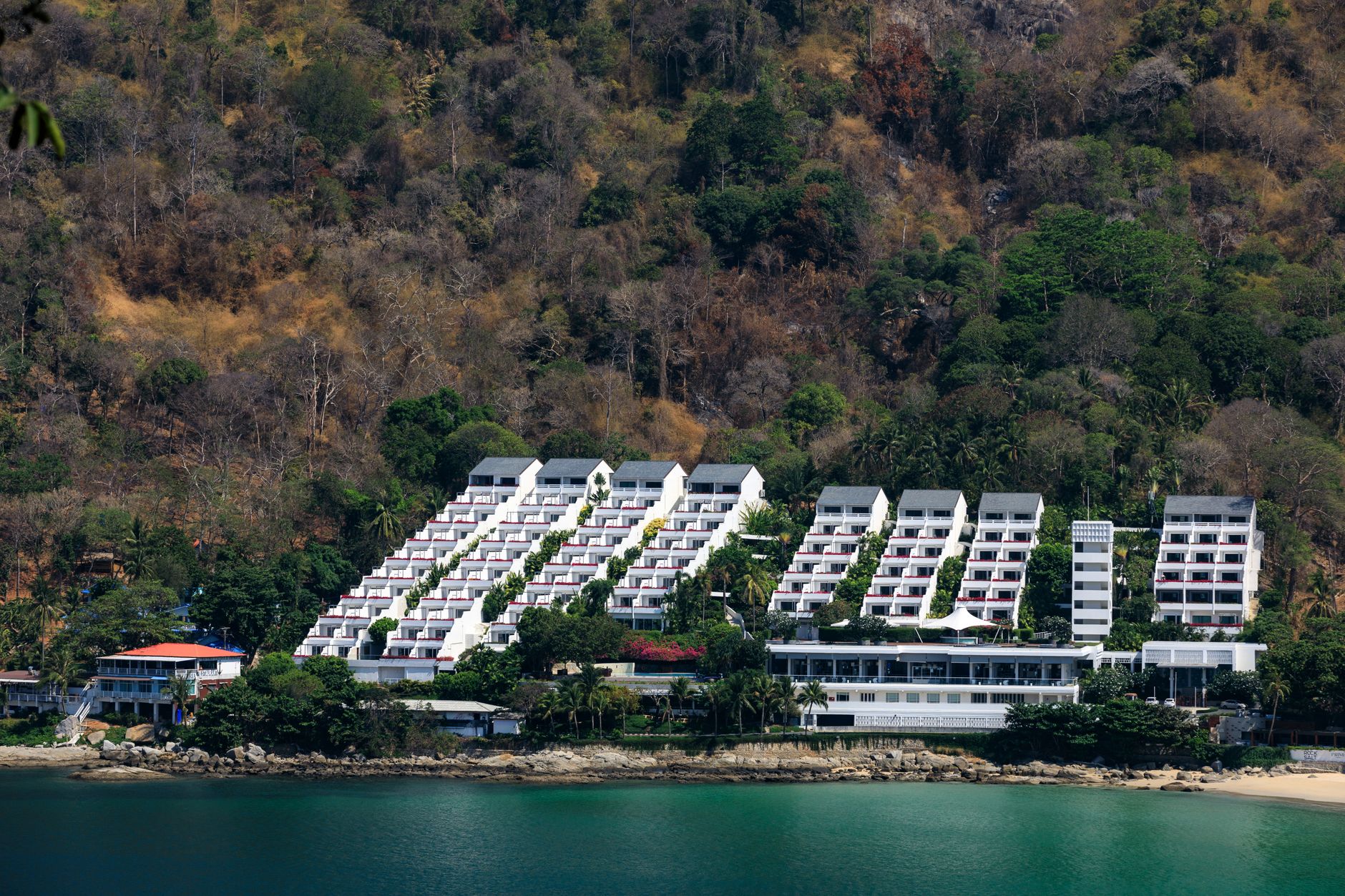 Phuket, Thailand - A scenic view of a modern resort nestled on the lush coastline of Phuket, Thaila